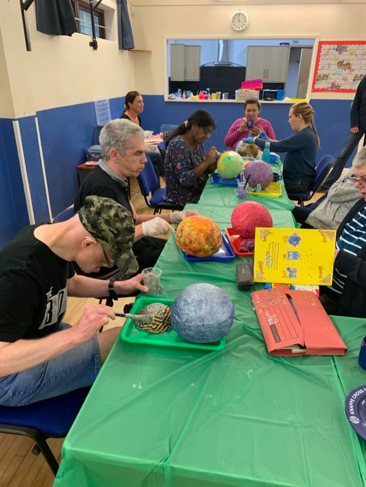 Group arts and crafts session around a table