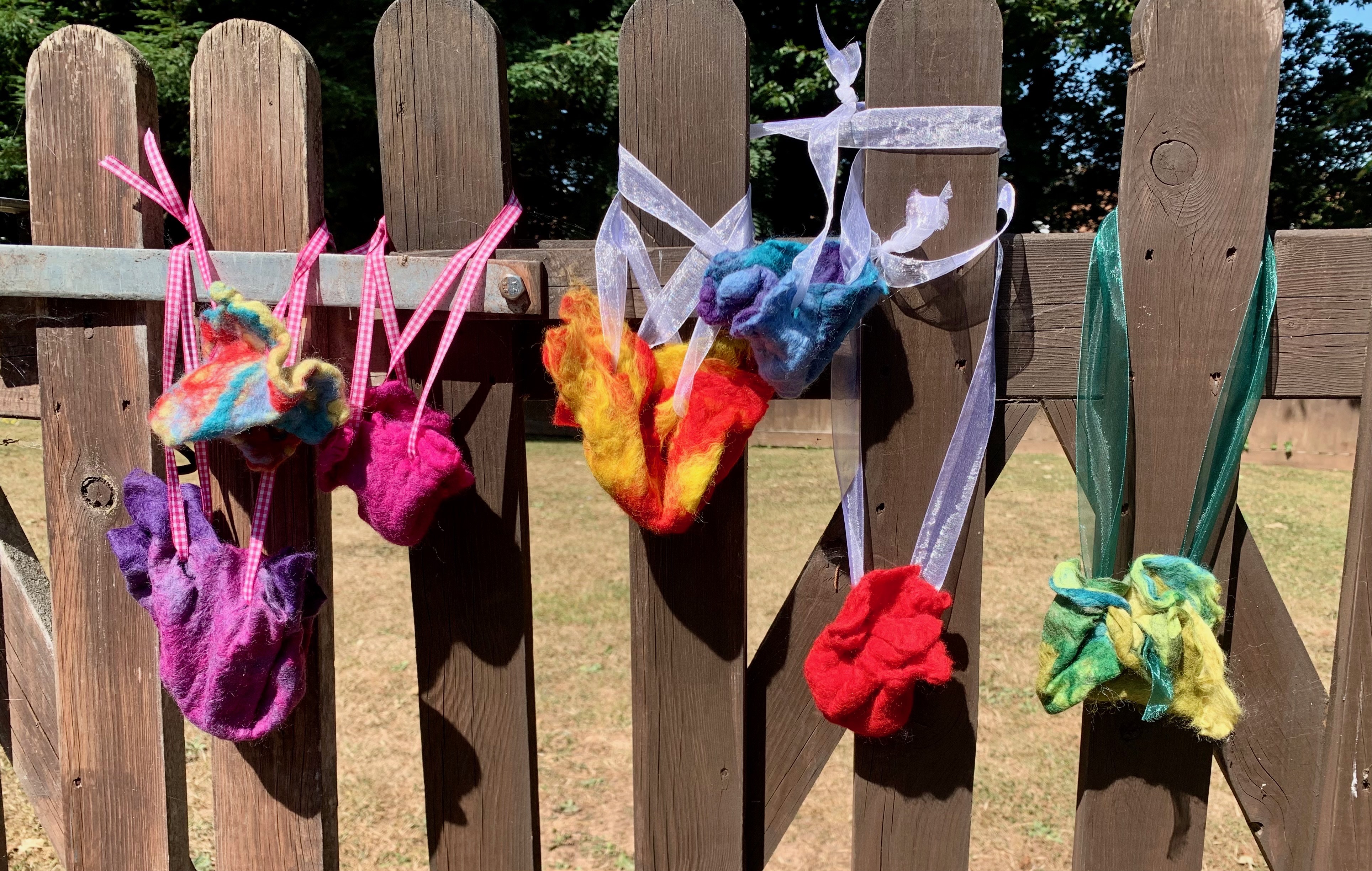 Beautiful handmade felt flowers in various colors displayed outdoors