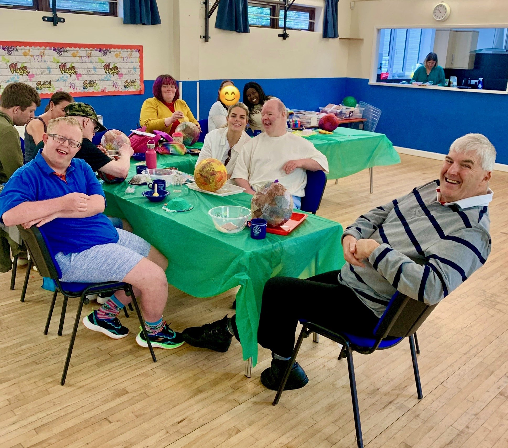 Happy participants enjoying creative activities together around a table at Creative Serenity